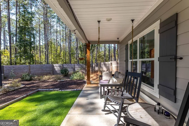a view of a hallway with wooden floor and entryway