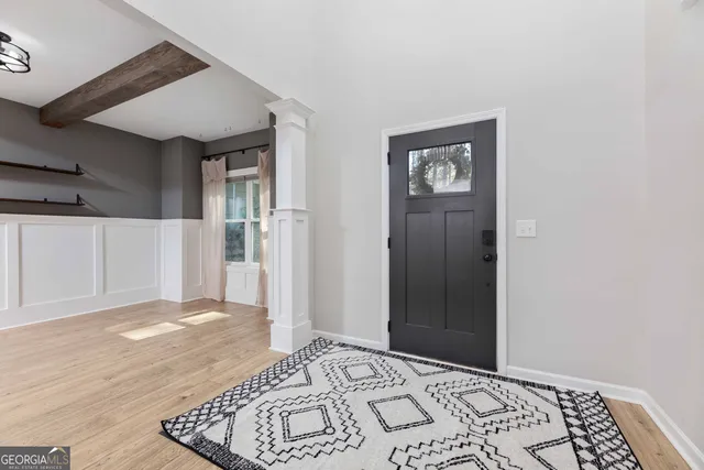 a view of empty room with wooden floor