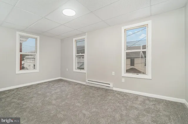 an empty room with windows and closet