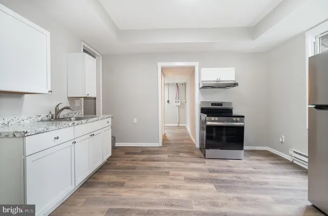 a kitchen with granite countertop a stove and a refrigerator