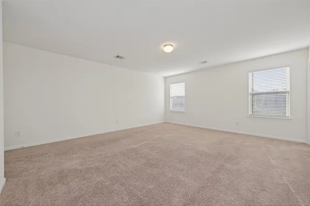 a spacious bathroom with a tub sink shower and mirror