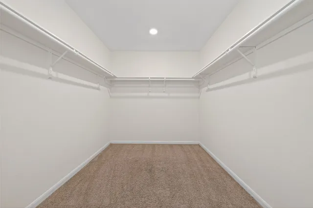 a bathroom with a double vanity sink mirror and a bathtub with a window