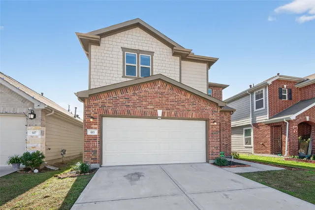 a front view of a house with a garden and plants