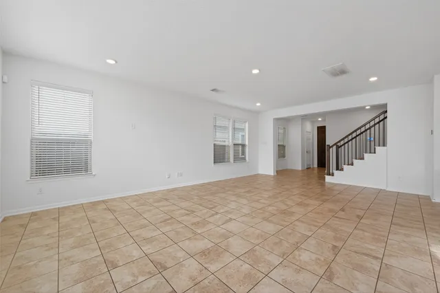 a open kitchen with kitchen island granite countertop a sink and a stove top oven
