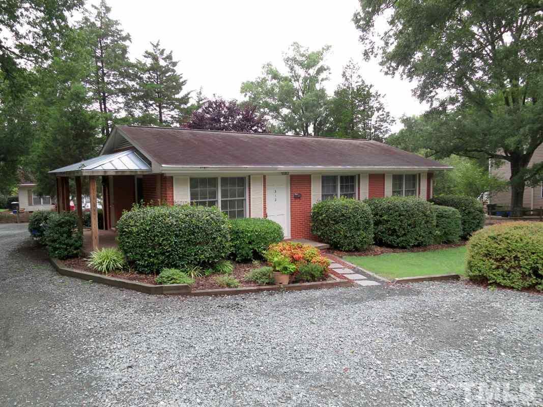 312 Davie Road Carrboro, NC 27510 - Photo 1 of 14 a front view of a house with a yard and green space