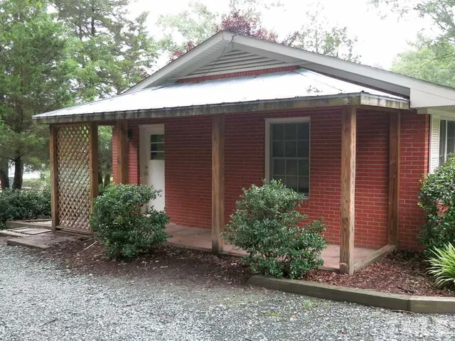 a view of a house with a yard and plants