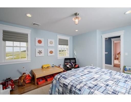 25 Bayberry Road Scituate, MA 02066 - Photo 19 of 28 a bedroom with a bed and a chandelier