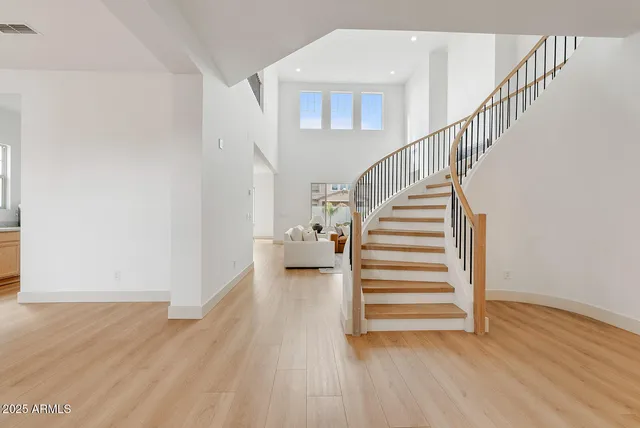 a view of entryway and hall with wooden floor