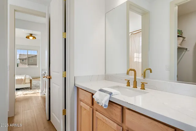 a view of a livingroom with wooden floor and a sink
