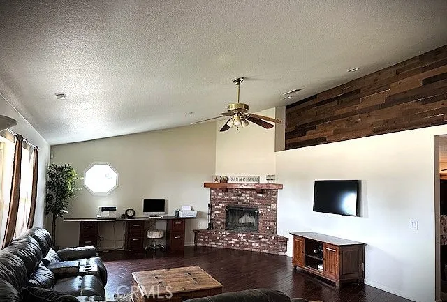 a living room with furniture a fireplace and a flat screen tv