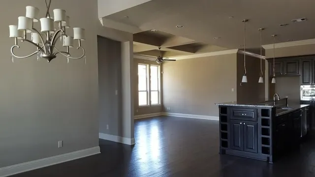 a kitchen with stainless steel appliances granite countertop a sink a stove and a refrigerator