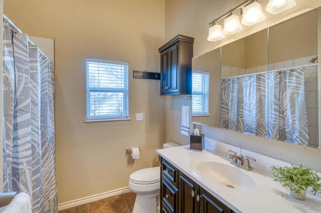 a bathroom with a sink toilet and a mirror