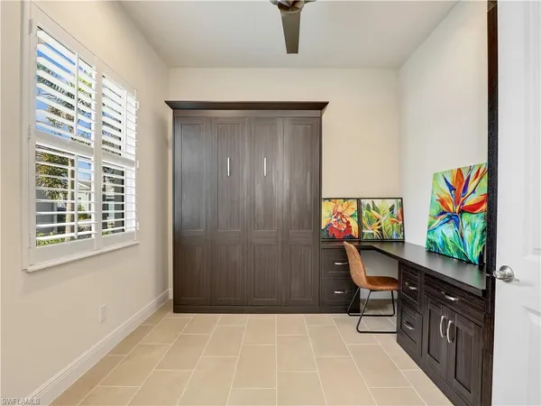a bedroom with a bed and a flat tv screen on dresser