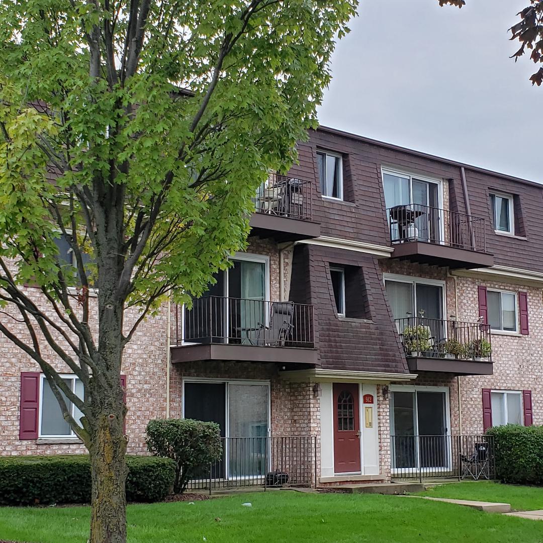 912 South Plum Grove Road, Unit 122 Palatine, IL 60067 - Photo 1 of 18 a front view of a building with garden