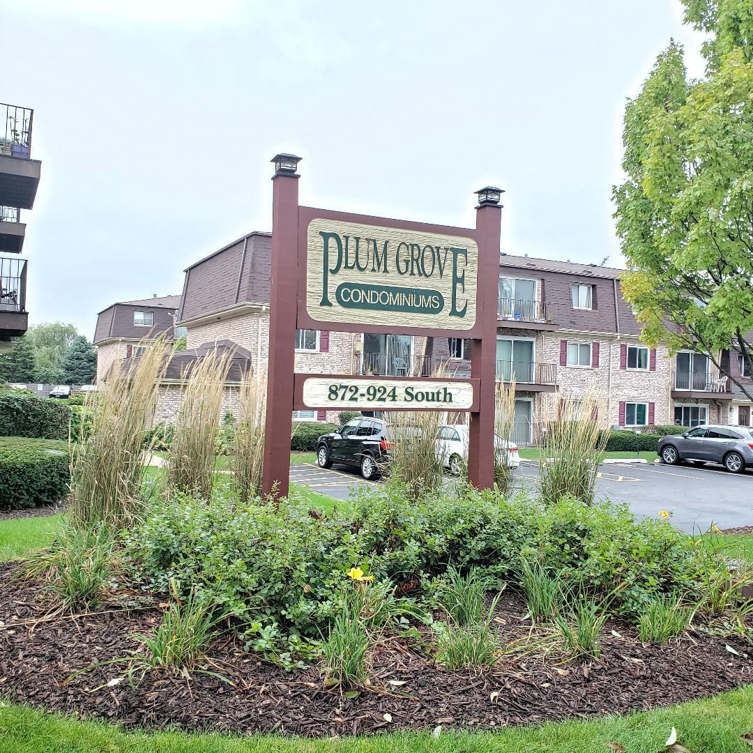 912 South Plum Grove Road, Unit 122 Palatine, IL 60067 - Photo 2 of 18 a sign on the side of a building
