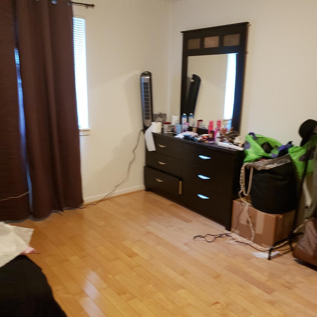 912 South Plum Grove Road, Unit 122 Palatine, IL 60067 - Photo 14 of 18 a bedroom with a bed dresser and a mirror
