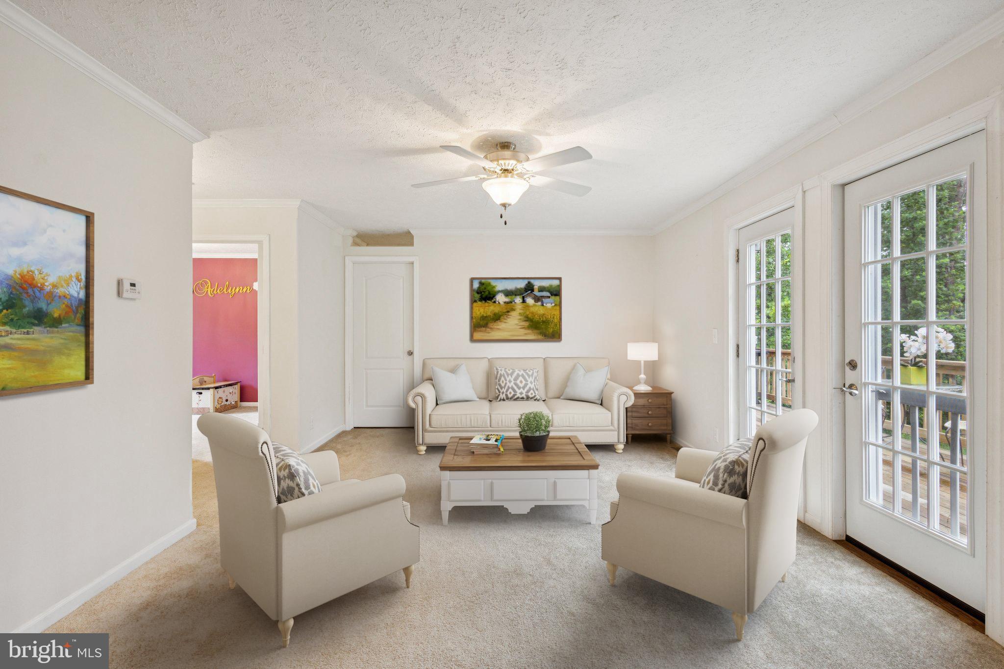 13153 Stonehouse Mountain Road Culpeper, VA 22701 - Photo 15 of 45 a living room with furniture two windows and a chandelier