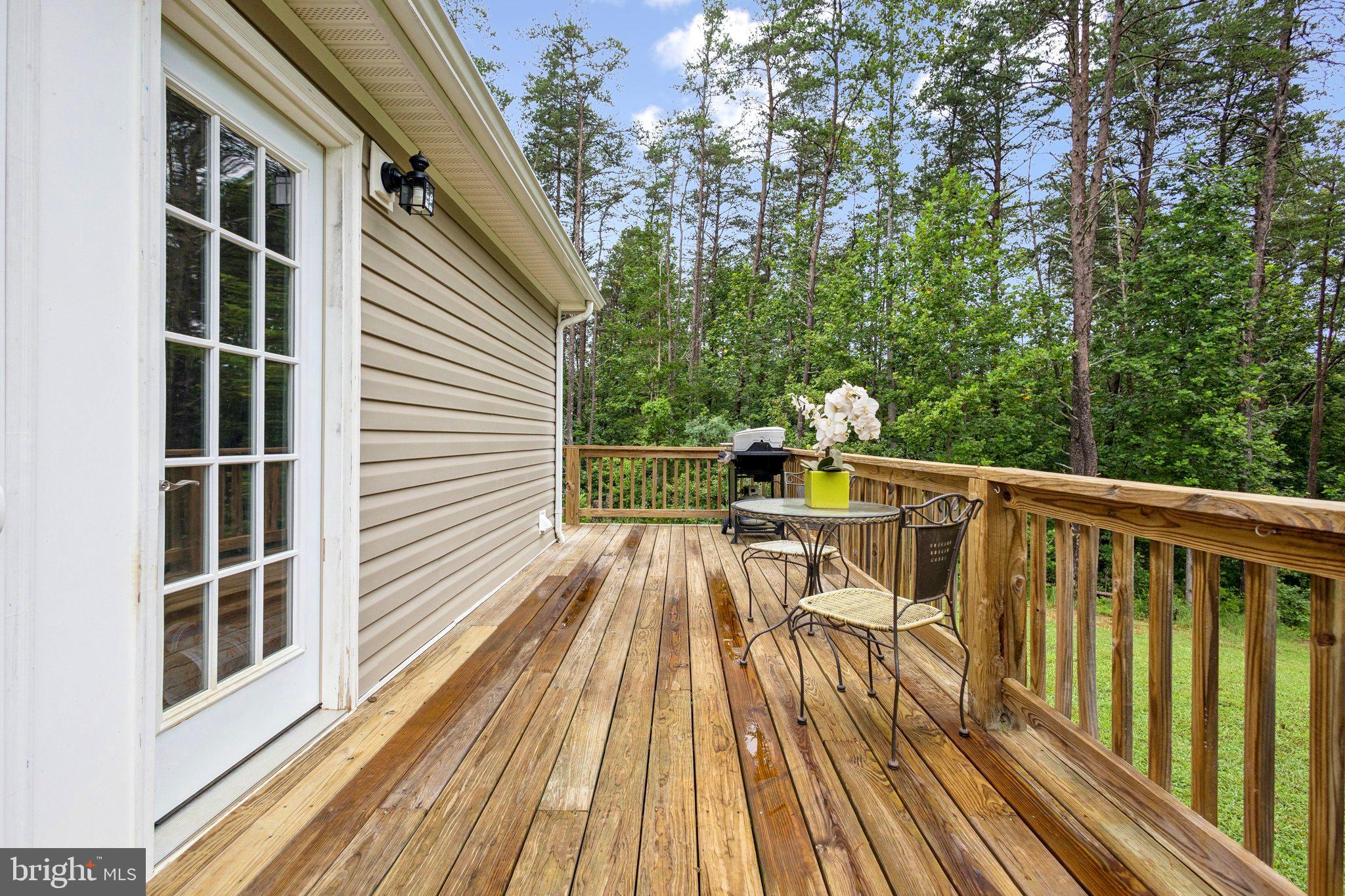 13153 Stonehouse Mountain Road Culpeper, VA 22701 - Photo 30 of 45 a view of deck with chairs and wooden floor