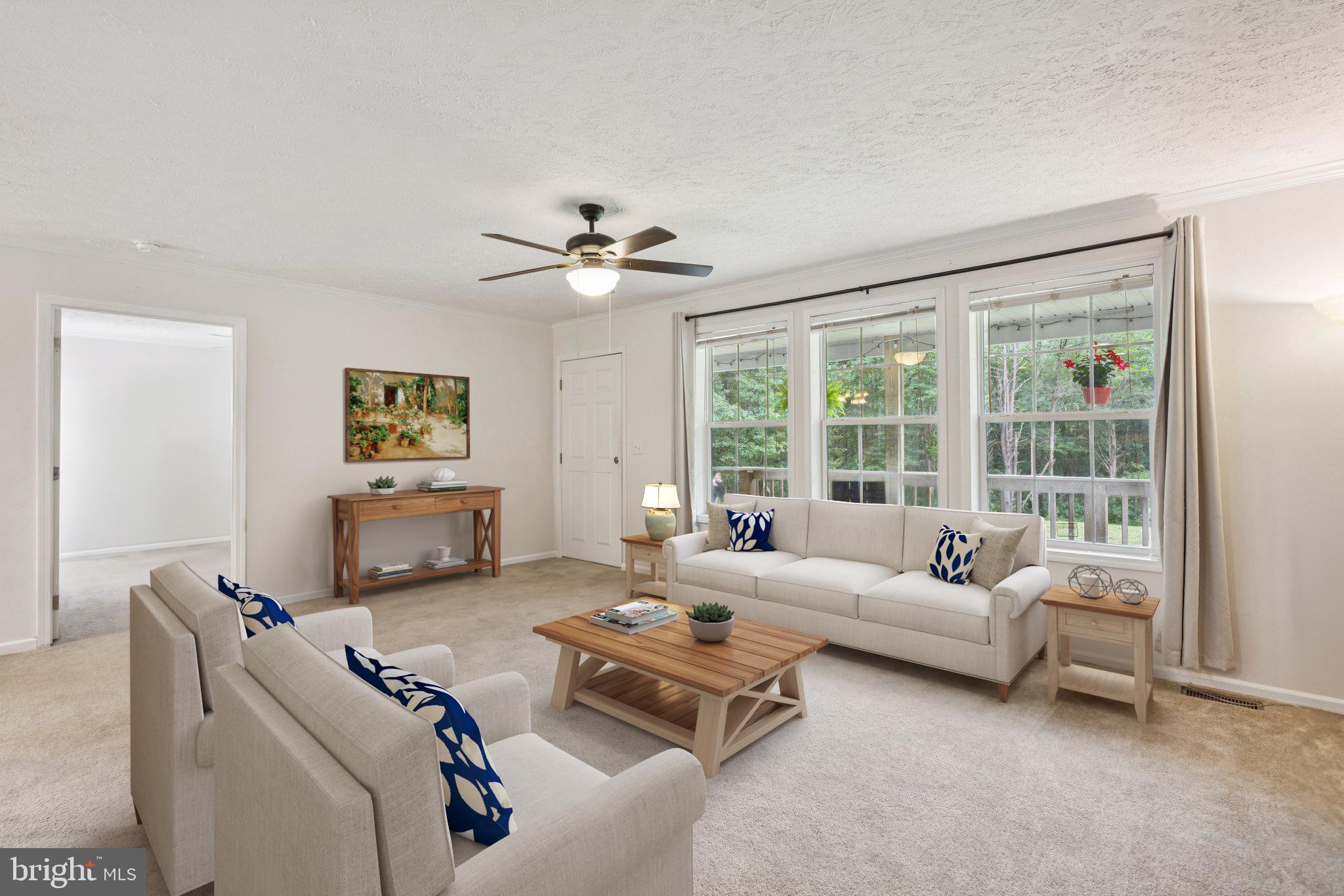 13153 Stonehouse Mountain Road Culpeper, VA 22701 - Photo 4 of 45 a living room with furniture and a large window