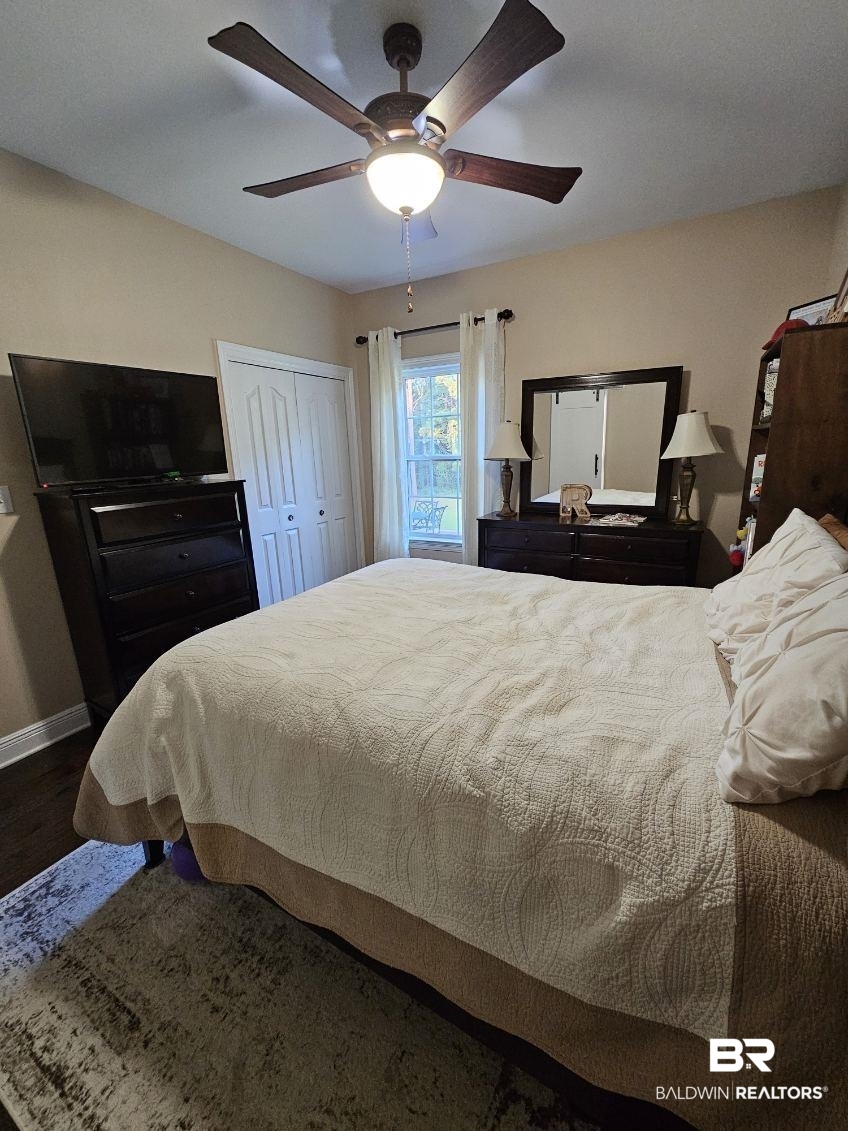 41416 Davis Duck Road Bay Minette, AL 36507 - Photo 48 of 72 Bedroom featuring ceiling fan, a closet, and hardwood / wood-style flooring