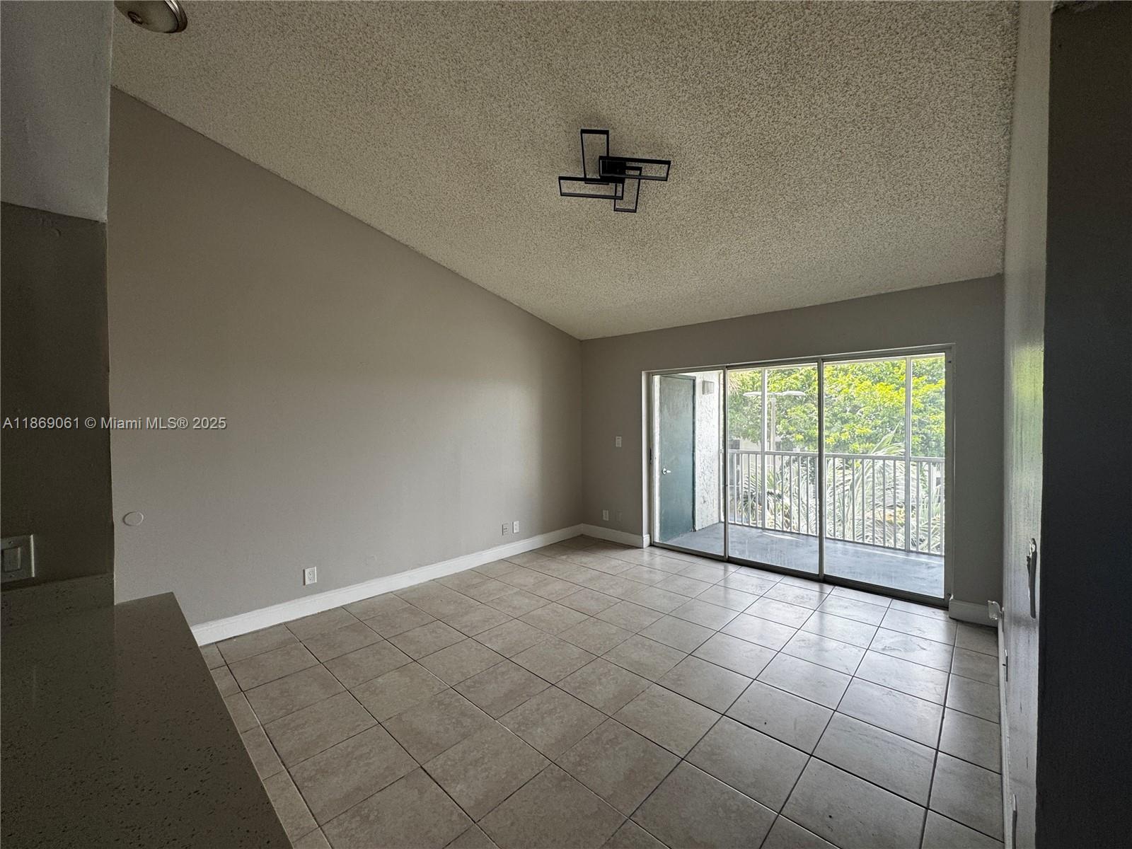 5780 Rock Island Road, Unit 375 Tamarac, FL 33319 - Photo 12 of 26 a view of an empty room with a window