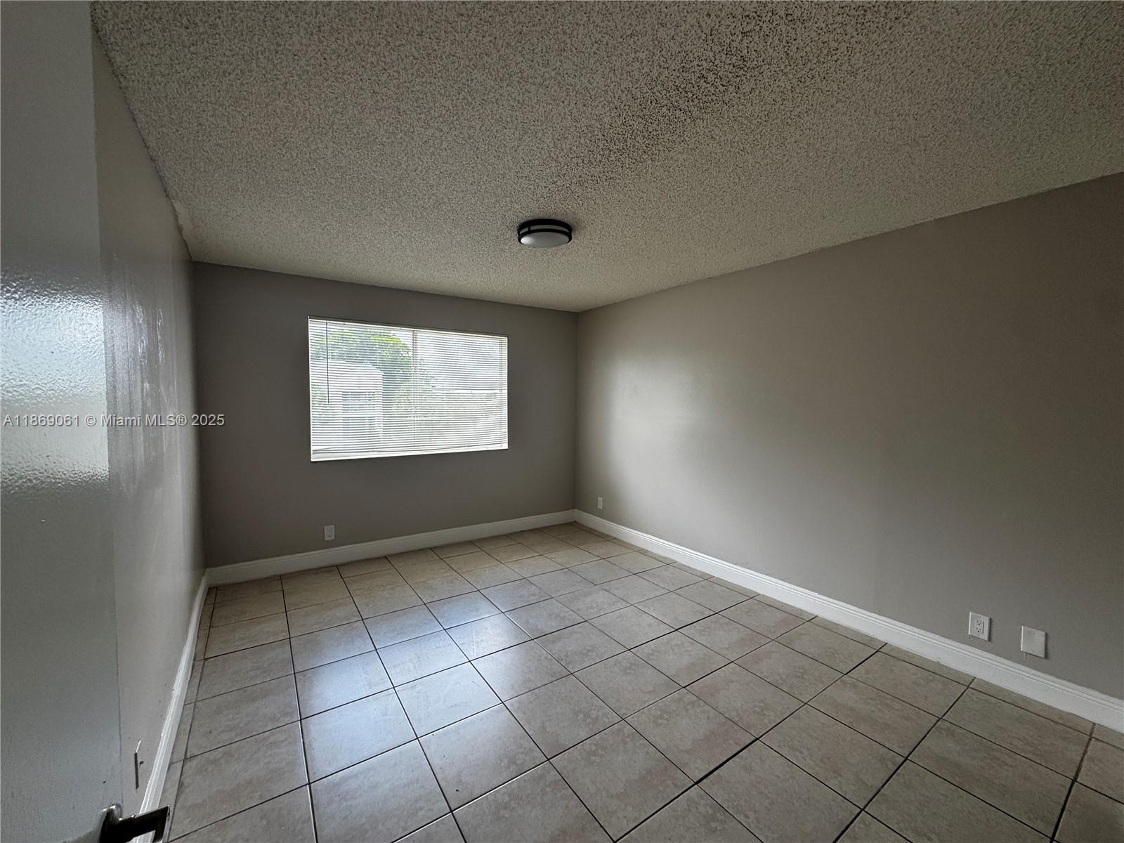 5780 Rock Island Road, Unit 375 Tamarac, FL 33319 - Photo 13 of 26 an empty room with windows