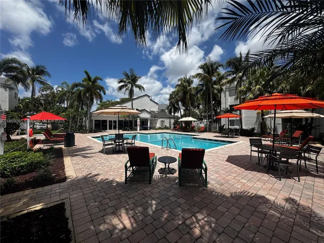a view of a swimming pool with outdoor seating
