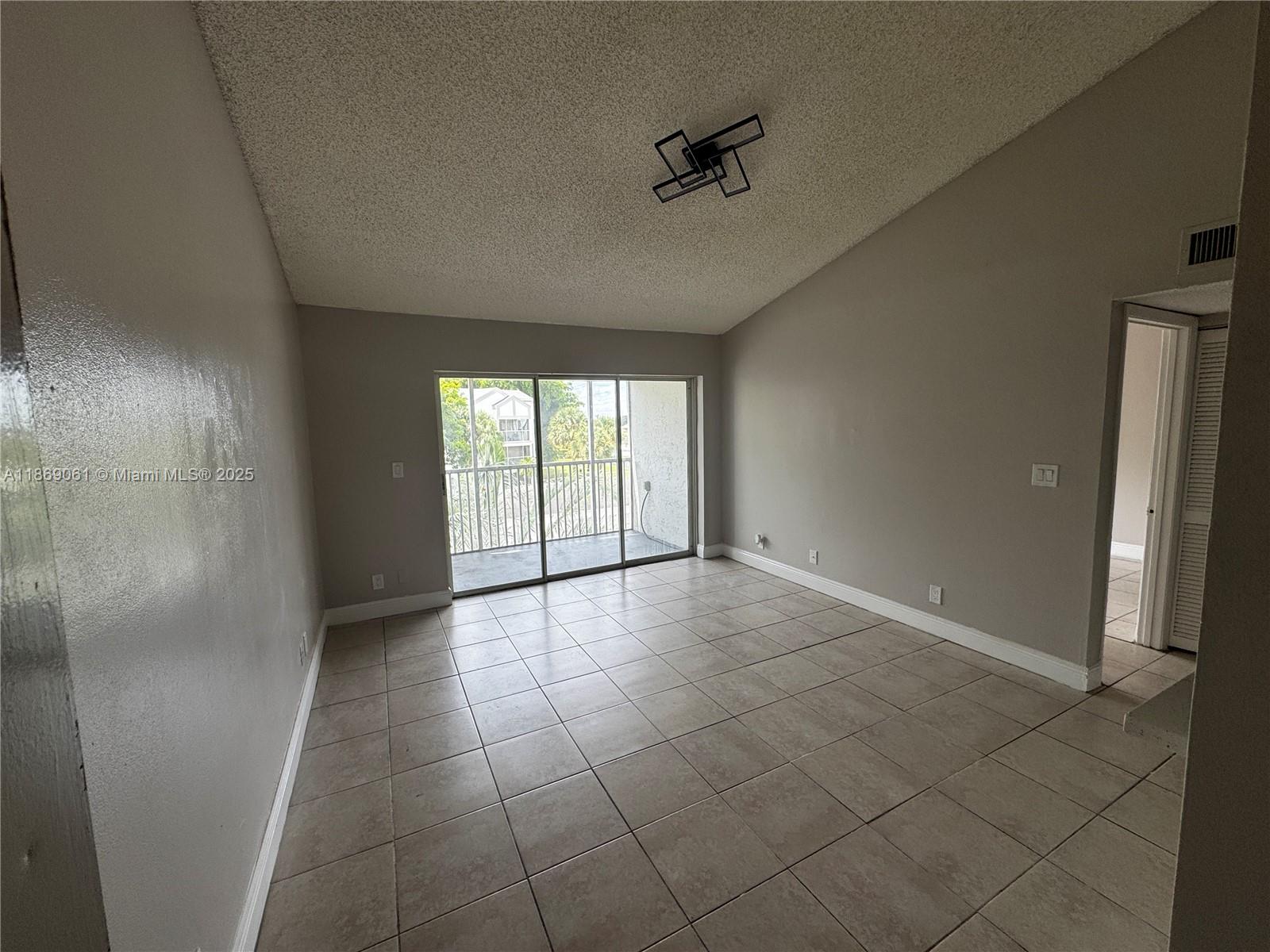 5780 Rock Island Road, Unit 375 Tamarac, FL 33319 - Photo 6 of 26 a view of an empty room and a window