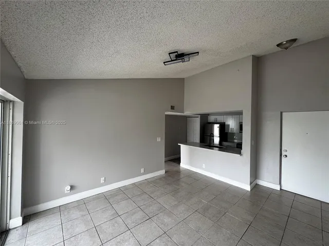 a view of a hallway with a kitchen