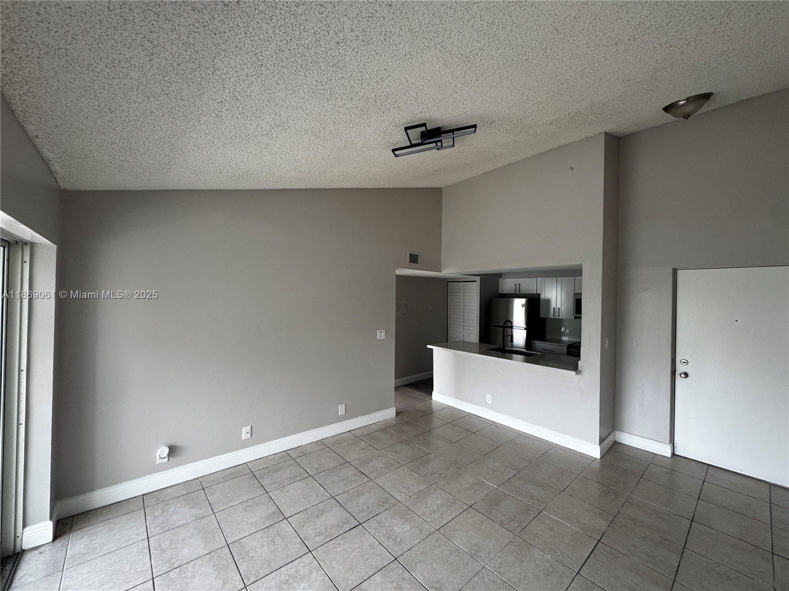 5780 Rock Island Road, Unit 375 Tamarac, FL 33319 - Photo 7 of 26 a view of a hallway with a kitchen