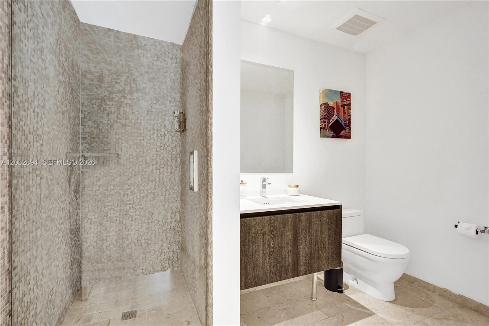 88 Southwest 7th Street, Unit 2210 Miami, FL 33130 - Photo 15 of 24 Spa-style bath with walk-in mosaic tile shower and modern floating vanity.