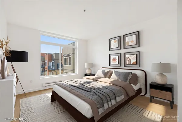 a bedroom with a large bed and a window
