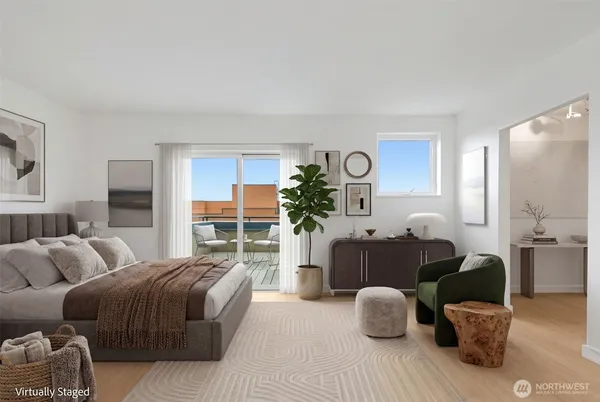 a bedroom with furniture and a large window