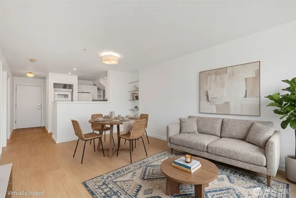 a living room with furniture a rug and a table