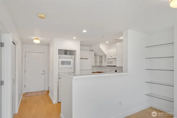 a view of a kitchen with refrigerator and a sink