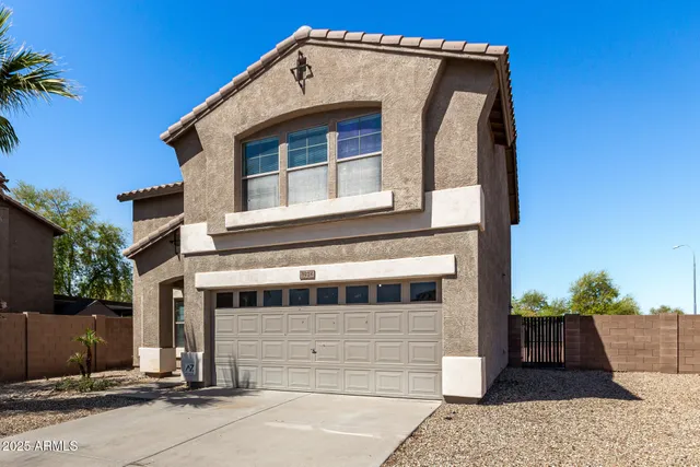 a front view of a house with a garage
