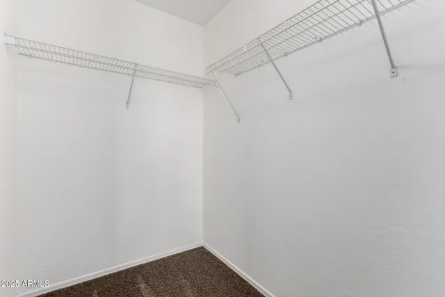 an empty room with ceiling fan and window