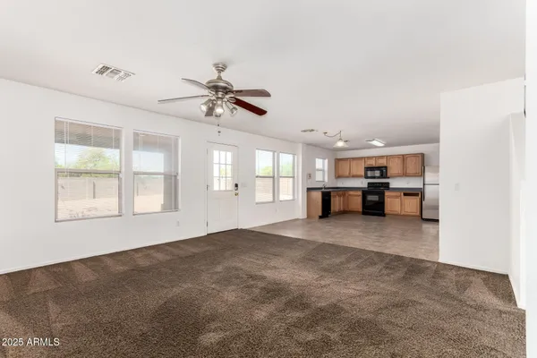 a view of a livingroom with a kitchen stove and a window