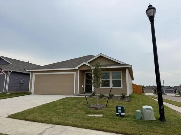 a front view of a house with a yard and potted plants