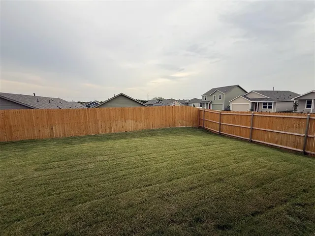 a kitchen with stainless steel appliances kitchen island granite countertop a refrigerator and a stove top oven