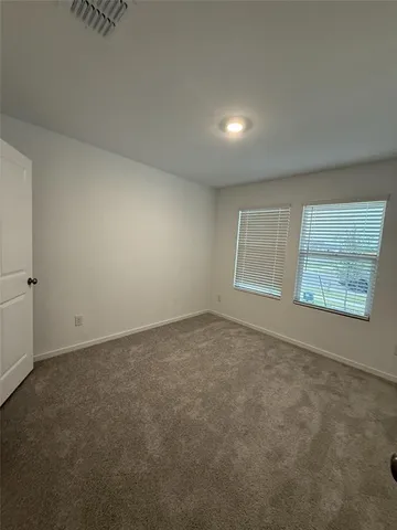 a bathroom with a double vanity sink toilet and mirror