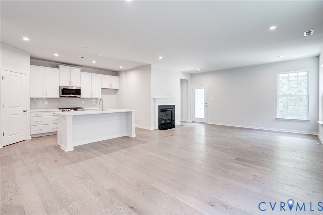 0 Canoe Pointe Loop Moseley, VA 23120 - Photo 2 of 15 a view of kitchen with kitchen island a sink wooden floor and stainless steel appliances