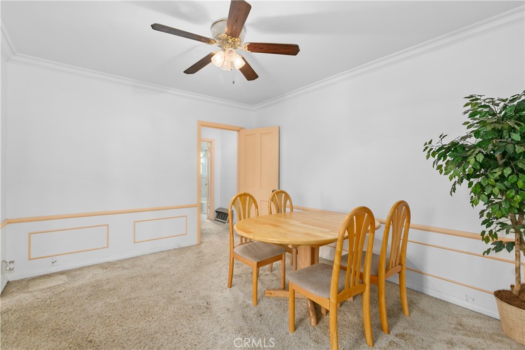 1615 North Van Ness Avenue Compton, CA 90221 - Photo 13 of 36 a view of a dining room with furniture and a potted plant