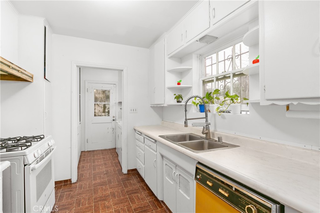 1615 North Van Ness Avenue Compton, CA 90221 - Photo 15 of 36 a kitchen with a sink and a refrigerator