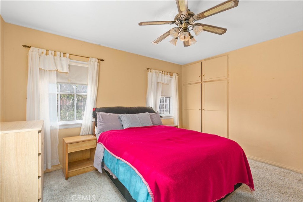 1615 North Van Ness Avenue Compton, CA 90221 - Photo 26 of 36 a bedroom with a bed and a chandelier