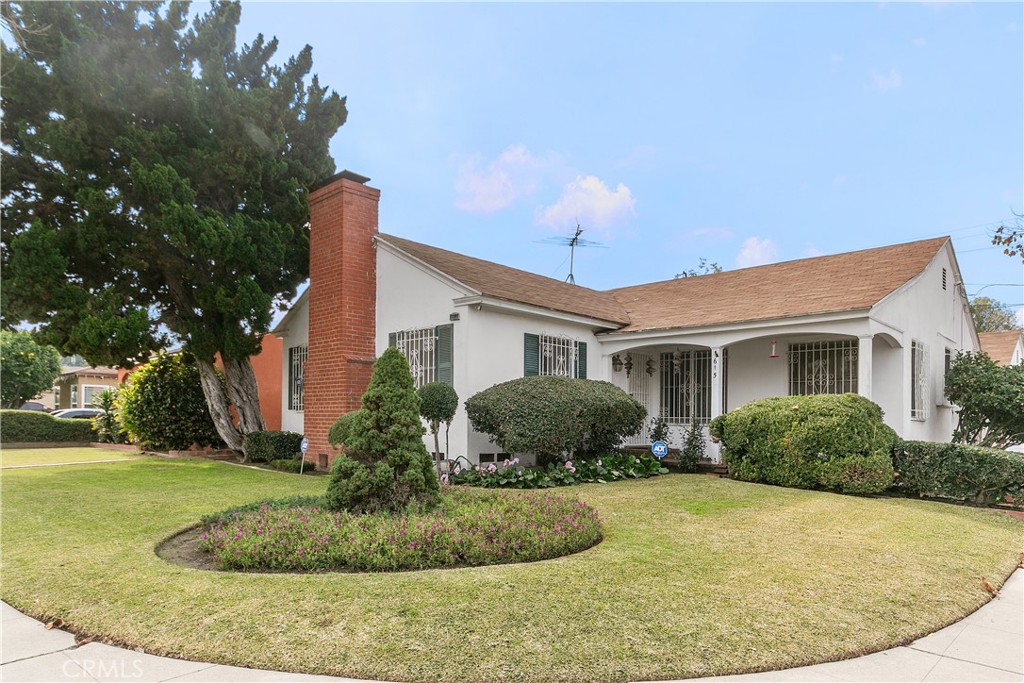 1615 North Van Ness Avenue Compton, CA 90221 - Photo 3 of 36 a front view of a house with a yard and trees