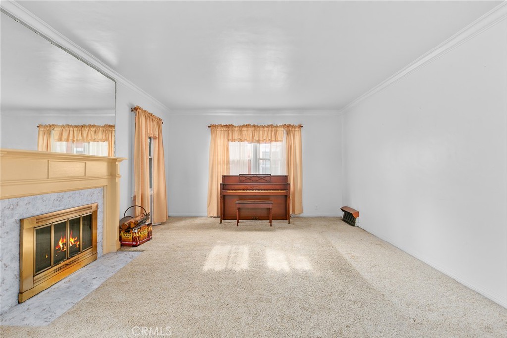 1615 North Van Ness Avenue Compton, CA 90221 - Photo 6 of 36 an empty room with windows and fireplace