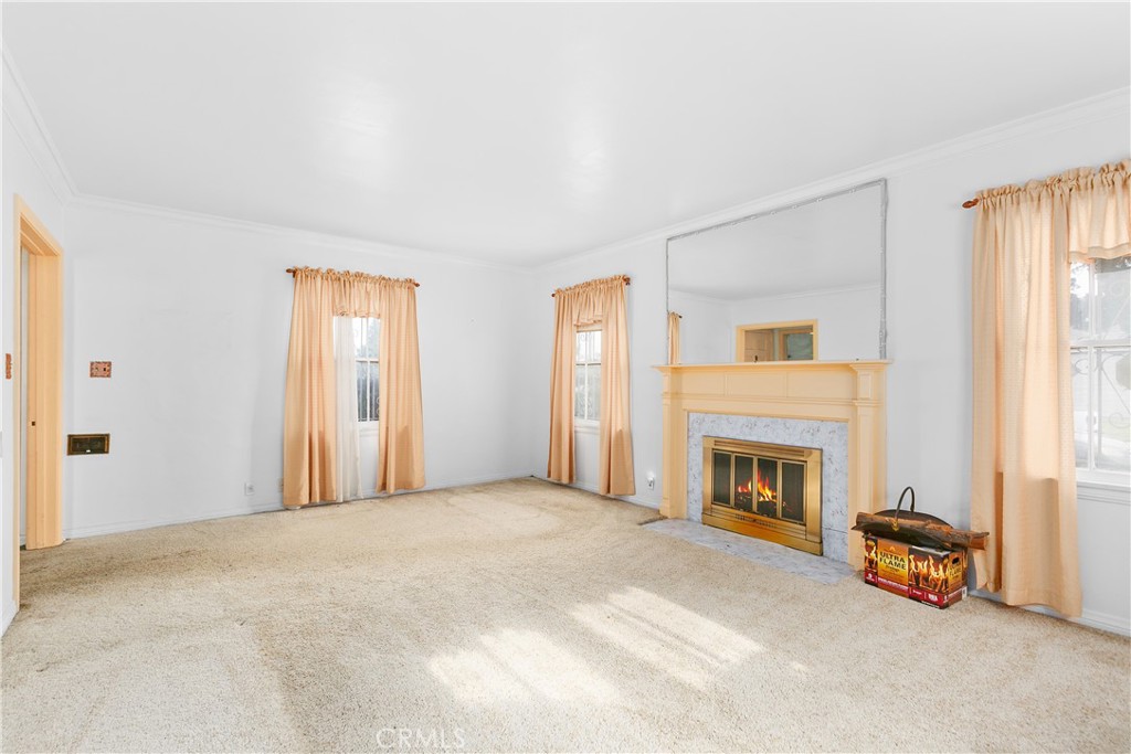 1615 North Van Ness Avenue Compton, CA 90221 - Photo 8 of 36 an empty room with furniture and a fireplace