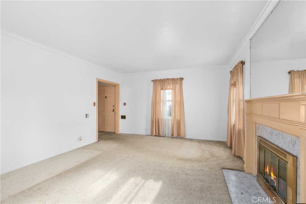 1615 North Van Ness Avenue Compton, CA 90221 - Photo 9 of 36 a view of an empty room with a fireplace