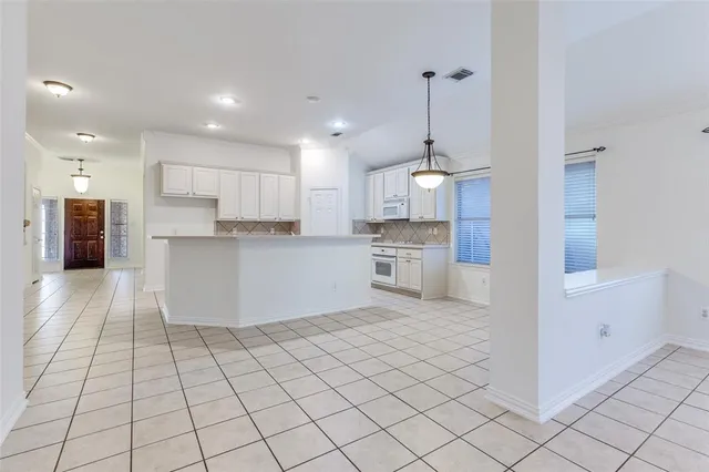 a kitchen with stainless steel appliances kitchen island granite countertop a refrigerator and a stove top oven